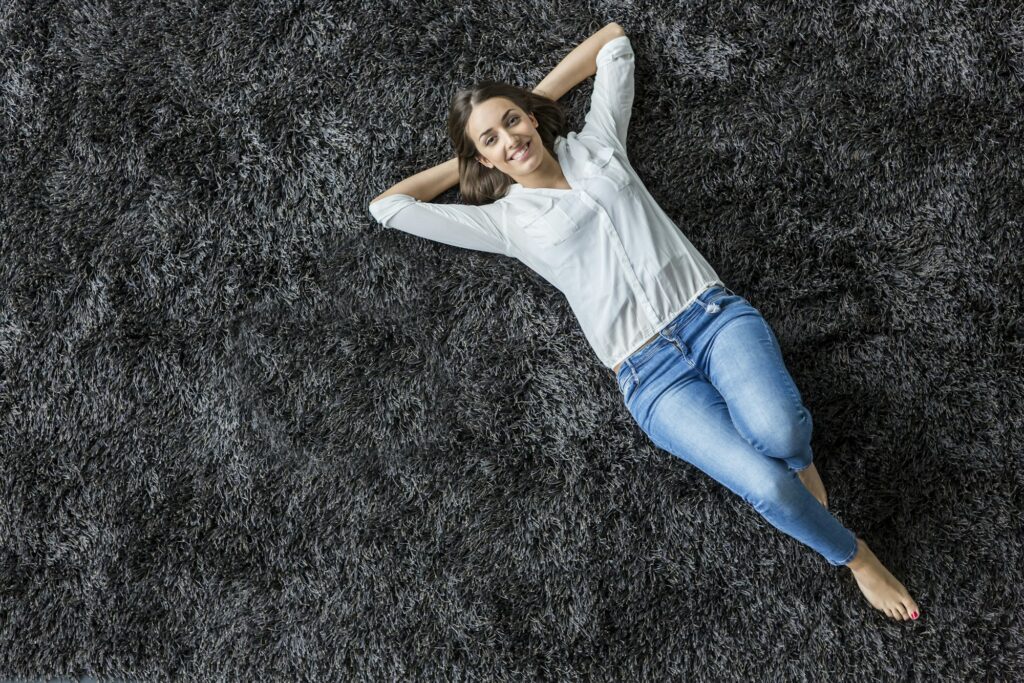 Young woman laying on the carpet